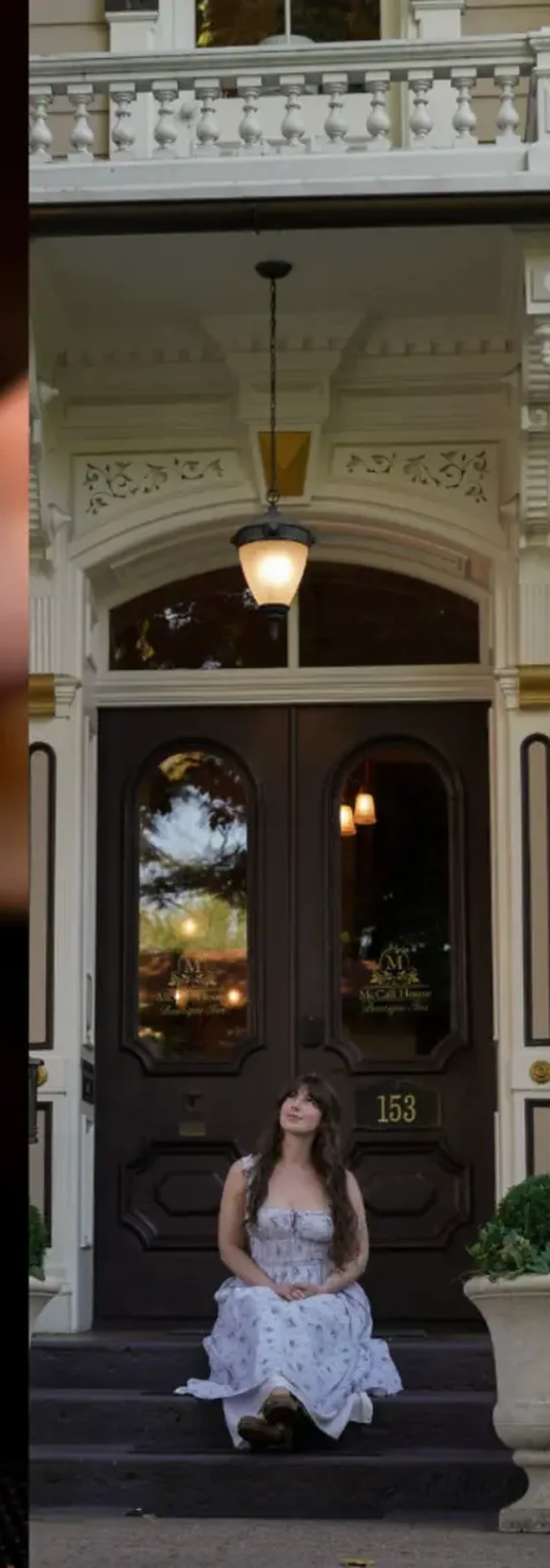Guest seated at a historic hospitality entrance