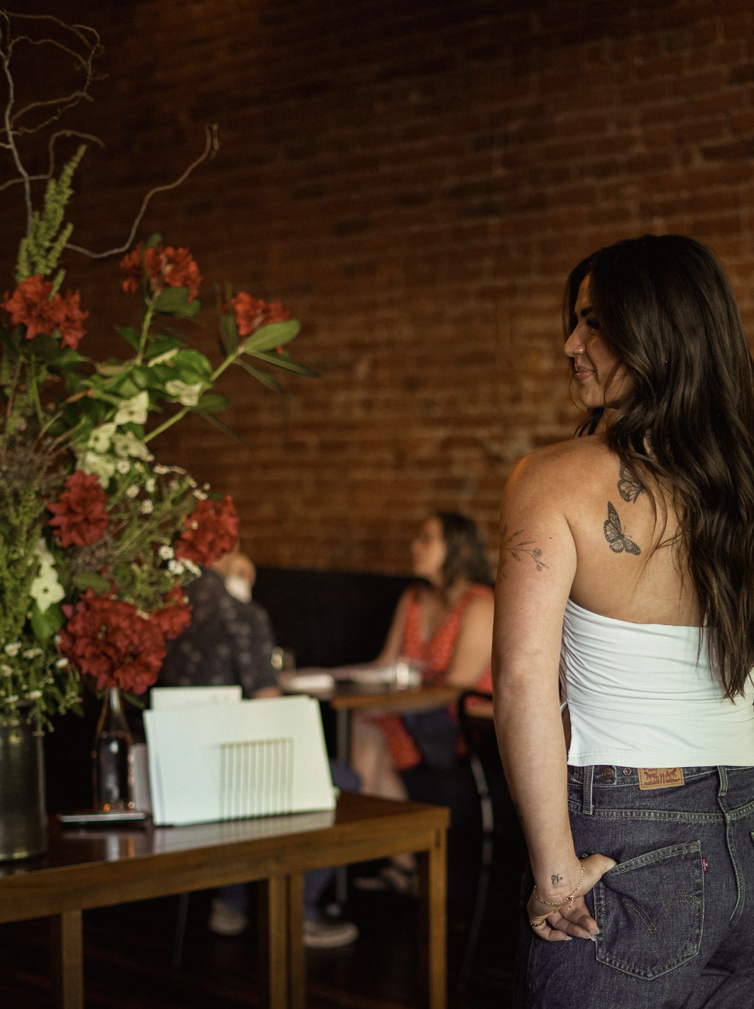 A woman enjoying a restaurant evening, facing toward the Work page headline